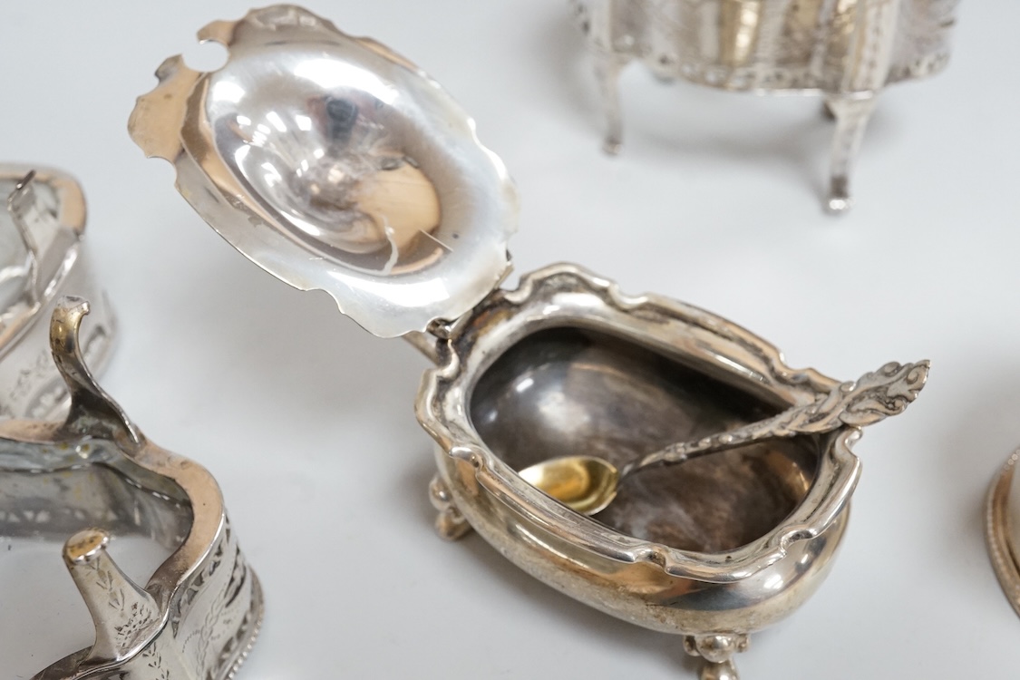 A pair of George III pierced silver shaped oval salts by Hester Bateman, London, 1783 (a.f.), with clear glass liners, together with one other George III silver oval salt, London, 1783 and two later silver mustard pots.